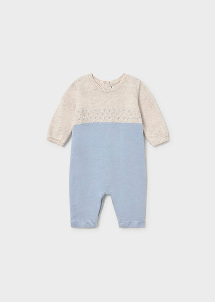 A baby boy knit one-piece jumpsuit in colorblock light blue and cream, featuring a textured knit pattern across the chest, 