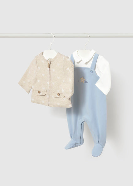 Baby clothing set featuring a short-sleeve zip-front jacket in light beige with subtle pattern and two flap pockets, and a light blue footed onesie over a white long-sleeve top with a small star detail.